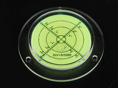 There is a yellow plastic circular level vial with scale on it.